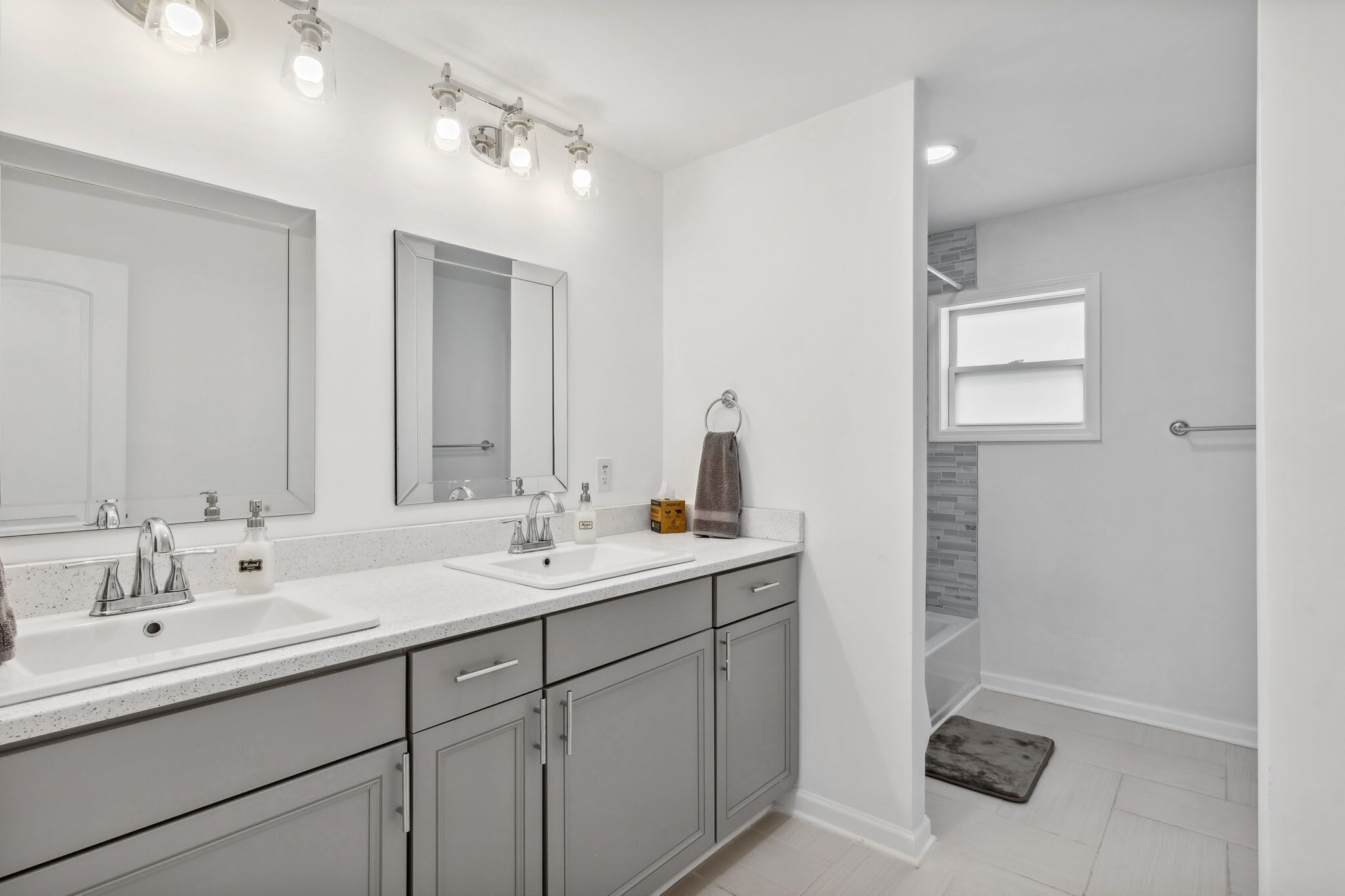 Bathtub, hair dryer, towels, shampoo