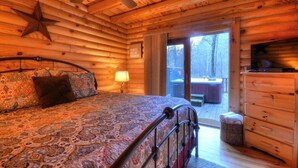 A log cabin bedroom with a bed, dresser, and a star decoration on the wall.