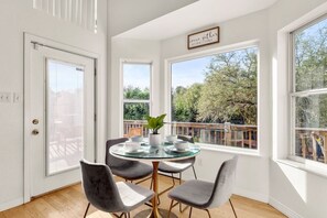Enjoy meals in this inviting dining area with a round table and comfortable seating for four.