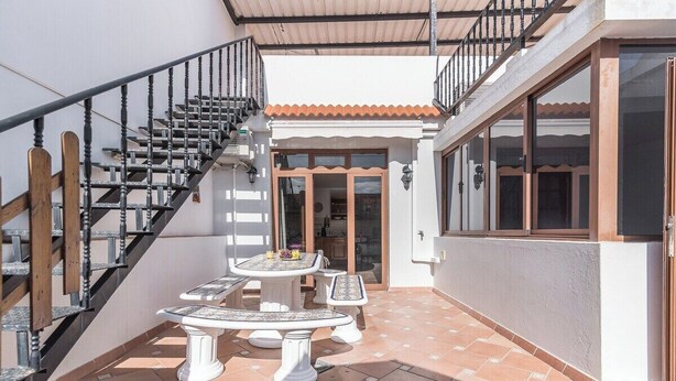 A covered patio with a staircase, outdoor seating, and a view of the interior. - Home2Book Charming Attic El Rincón de Telde, BBQ (Telde)