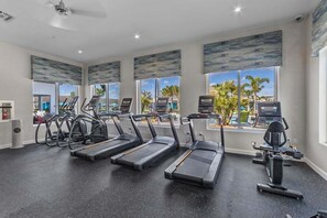 A gym with treadmills, elliptical machines, and a rowing machine. - Lakefront Pool & Spa | Steps to Clubhouse | Prime Storey Lake Location (Kissimmee)