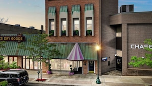 A two-story building with a brick facade, a green awning, and a Chase ATM. - Downtown Apartment! Large, Cozy, Family friendly private oasis in city center! (Petoskey)