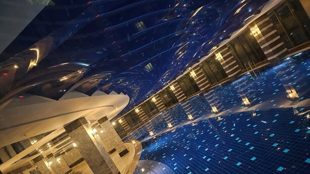 A modern hotel interior with a central pool area, multiple balconies, and a distinctive architectural design. - Sirius Town Residence and Spa (Antalya)