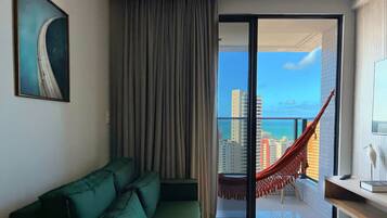 Deluxe Apartment | Living area | 32-inch TV with satellite channels