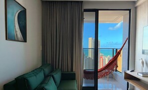 Deluxe Apartment | Living area | 32-inch TV with satellite channels