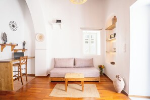 Signature Apartment | Living area | 32-inch Smart TV with cable channels, TV