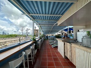A covered outdoor seating area with a view of the cityscape and railway tracks. - Hotel Casa Cielo Cartagena (Cartagena)