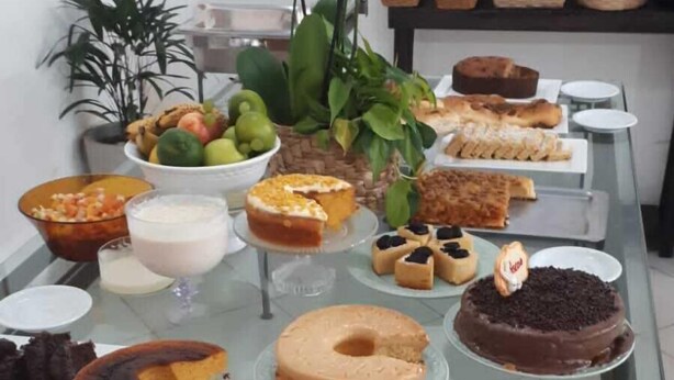 A buffet table with various desserts and fruits.
