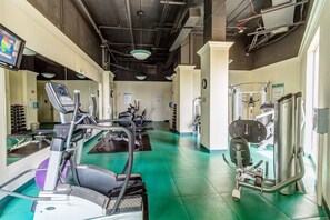 A gym with treadmills, ellipticals, and weight machines.