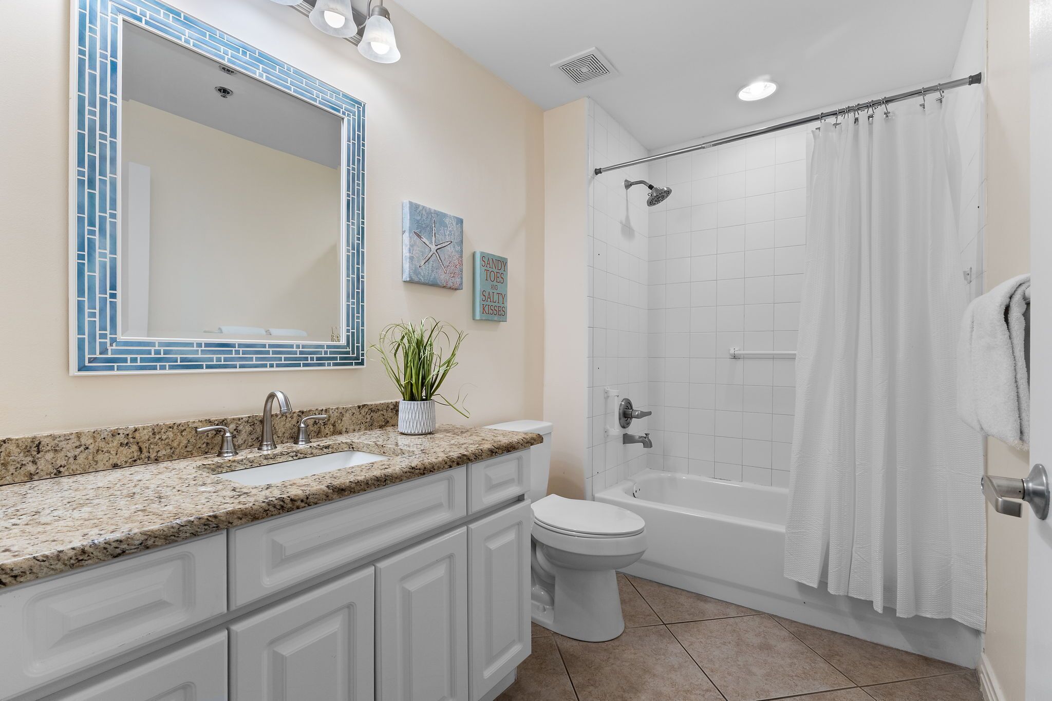 A bathroom with a sink, toilet, and shower.