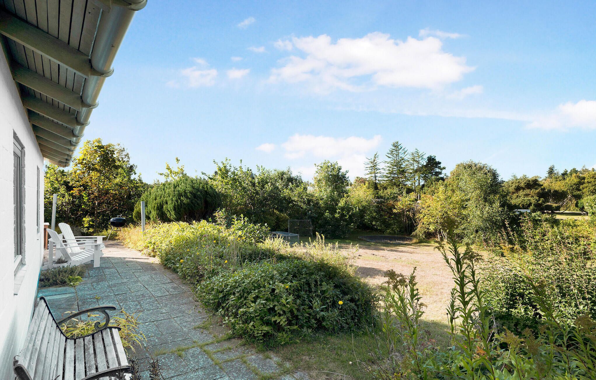 A patio with outdoor seating and a view of a natural landscape.