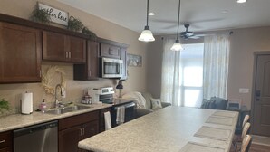 A modern kitchen with granite countertops, stainless steel appliances, and a central island. - PERFECT 2 bedroom, 1 bath Condo (Helena)