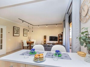 Enjoy a romantic dinner for two in this elegant dining area, complete with a beautifully set table and a delicious spread of pastries.