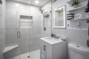 A modern bathroom with a glass-enclosed shower, a white sink, and a toilet. - Chicago charm! Quiet and inviting ! (Chicago)