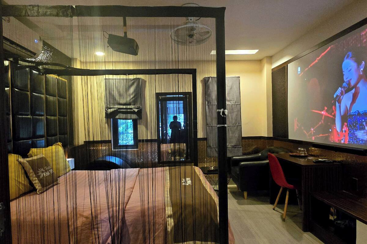 Una habitación de hotel moderna con una cama grande, una pantalla de televisión, un escritorio y una silla.