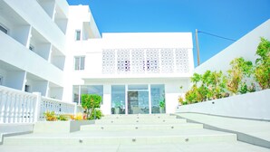 A modern building with a white facade, multiple balconies, and a staircase leading to the entrance. - Fresh hotel rhodes (Rhodes)