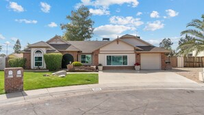 A single-story house with a garage, a front yard, and a mailbox. - Scottsdale Game House Heated Pool, Golf, Bowling (Scottsdale)