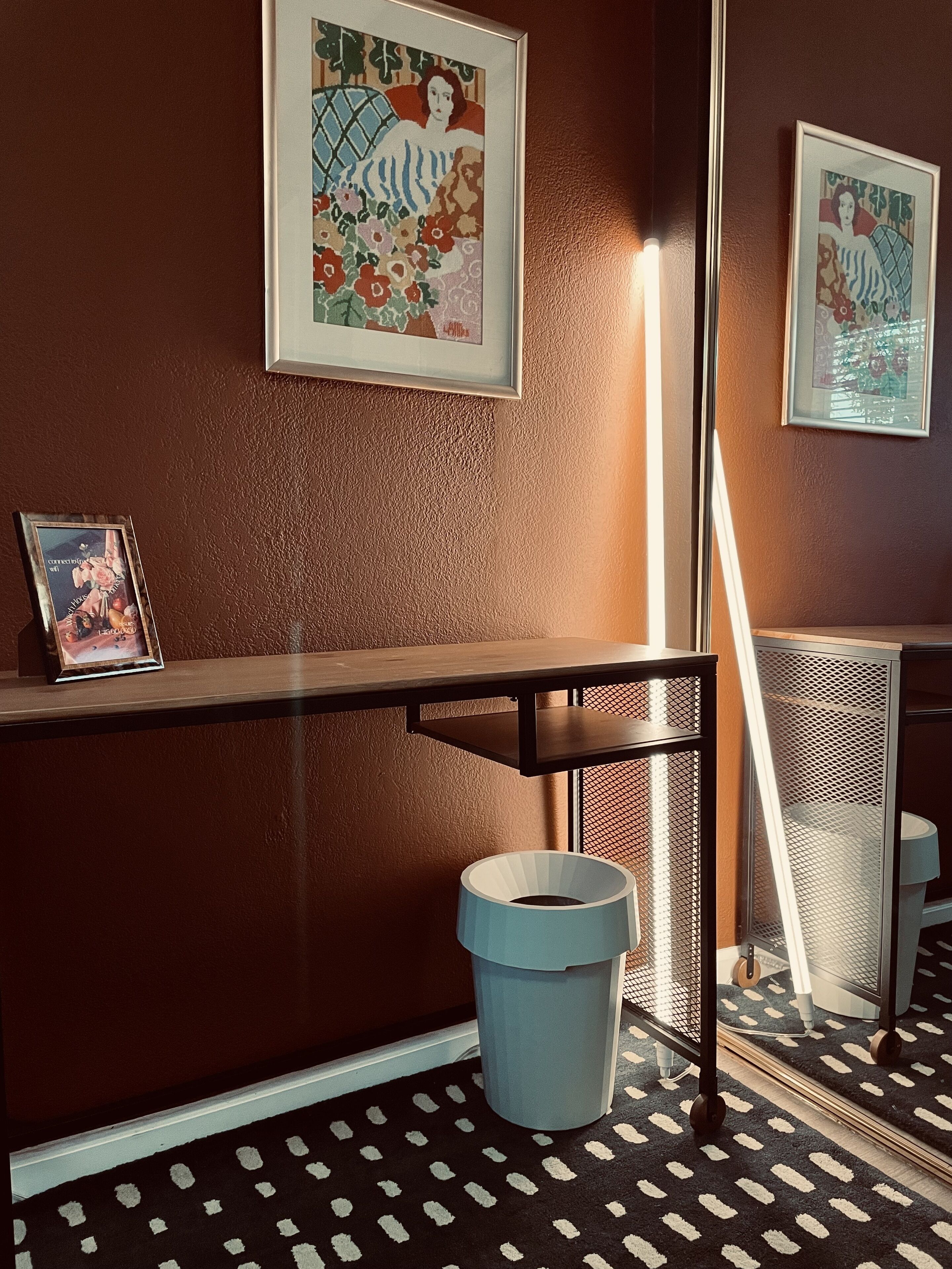 Desk-area amenities include a wifi sign, coaster and a waste bin.