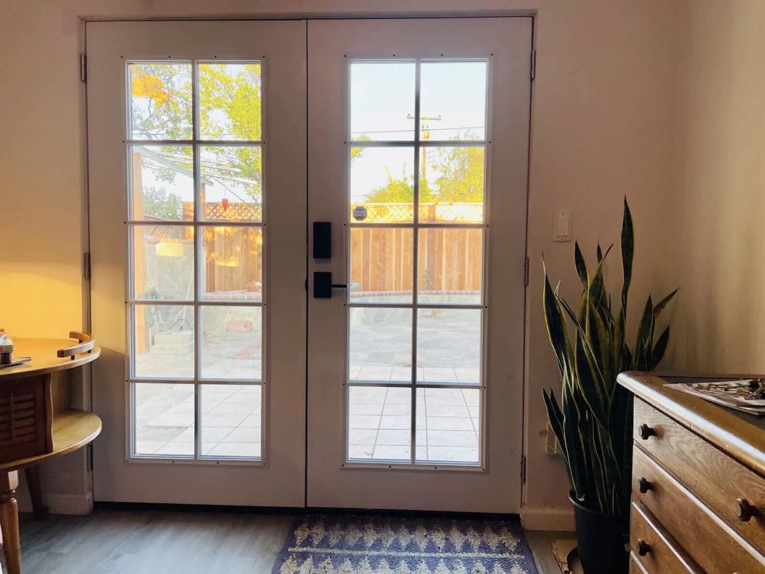 Private entry — surveys a fenced and gated back patio. Lots of light year-round.