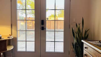 Private entry — surveys a fenced and gated back patio. Lots of light year-round.