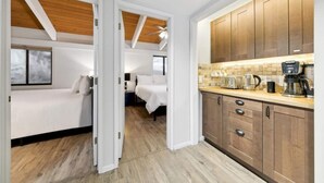 A compact hotel room with a kitchenette, a bed, and a small bathroom. - Lake View Treasure -  Luxury with Lake Views (Incline Village)