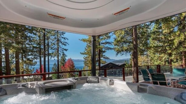 A hot tub area with a view of the lake and trees. - Lake View Treasure -  Luxury with Lake Views (Incline Village)