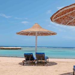 On the beach, beach umbrellas, beach towels, beach volleyball
