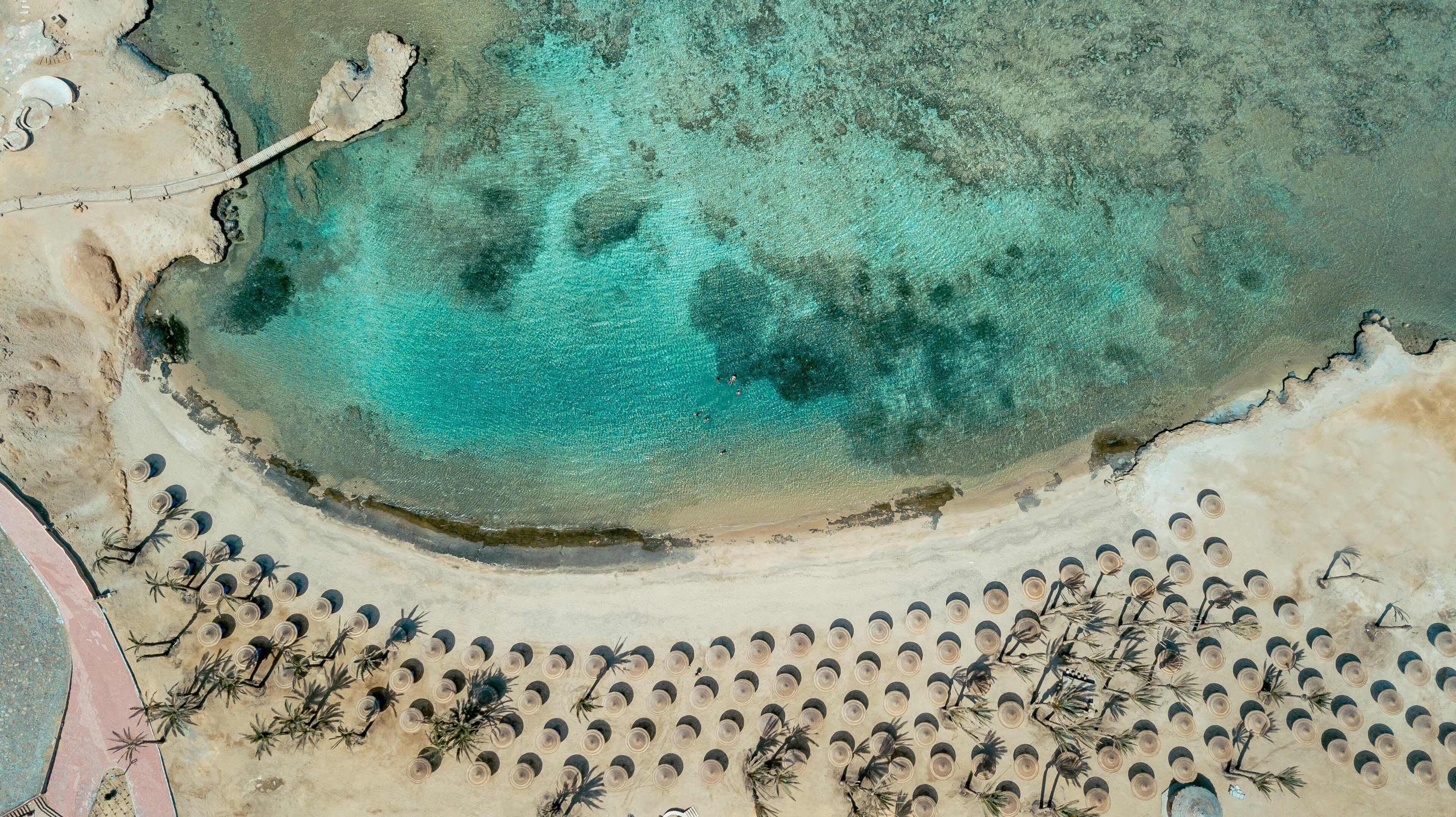On the beach, beach umbrellas, beach towels, beach volleyball