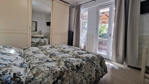 A bedroom with a bed, a wardrobe, and a sliding glass door to a balcony. - 150 sq. m. apartment in villa with private pool and Jacuzzi (Fabrica di Roma)