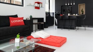 Design Apartment | Living area | 60-inch flat-screen TV with cable channels, TV, streaming services - New Design & Sunny Balcony in TLV Center (Tel Aviv)