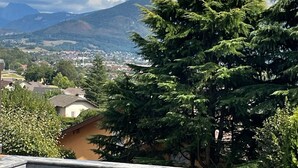 A swimming pool with a view of a mountain and a town in the background. - Exceptional mountain view, heated swimming pool, 10 minutes from Lake Annecy (sillingy)