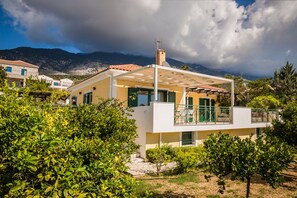 Set amidst lush greenery, this two-story property offers a balcony with a mountain view.