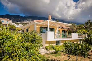 Set amidst lush greenery, this two-story property offers a balcony with a mountain view.