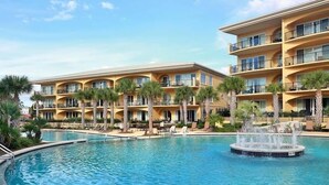 A hotel with multiple balconies, a swimming pool, and palm trees. - Adagio B-204 Beach Front - Beautiful Gulf Front Unit! (Santa Rosa Beach)