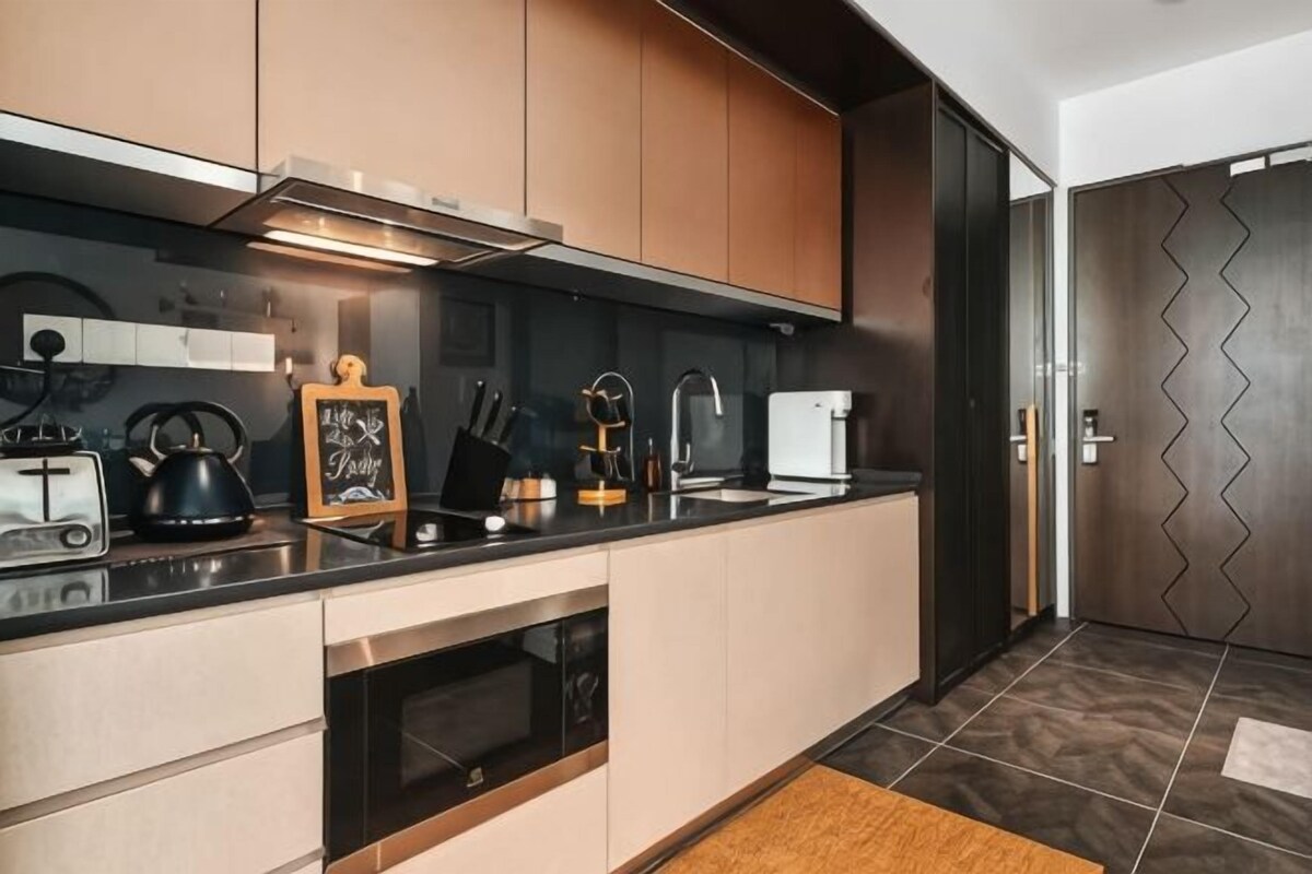 A modern kitchen with a built-in oven, a microwave, and a stovetop.