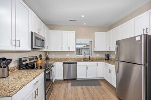 Fridge, microwave, oven, stovetop - Stylish New Build! 2BR Condo w/ Patio & Garage (Wyoming)