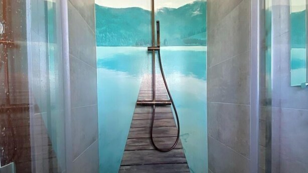 A narrow, tiled hallway with a wooden dock extending into a large, serene lake view. - Design villa with swimming pool and tennis court in a hectare of fully enclosed grounds (Le Pont-de-Beauvoisin)