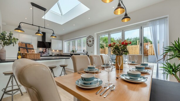 A modern kitchen with a dining area, skylights, and a view of the outdoors. - 3 bedroom accommodation in Square and Compass, near Haverfordwest (Square and Compass, near Haverfordwest)