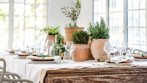 A dining table set with white tablecloths, terracotta pots with greenery, and wine glasses. - 18th century Provencal country house (Sarrians)