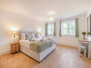 A bedroom with a bed, bedside tables, a desk, and a window. - 3 bedroom accommodation in Ruswarp, near Whitby (Ruswarp, near Whitby)