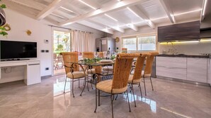 A modern kitchen with a dining area.