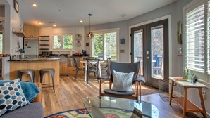 Une cuisine spacieuse dotée de meubles en bois, d’un îlot central et d’un coin repas avec une chaise et une table.