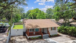 A single-story house with a front porch, a garage, and a driveway. - Charming Seminole Heights Stay with Free Parking (Tampa)