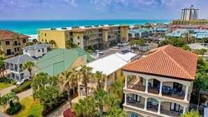 A coastal hotel with multiple buildings, a pool, and a view of the ocean. - Suzie Q, Luxury Beach House w/Private Pool Rooftop Deck (Destin)
