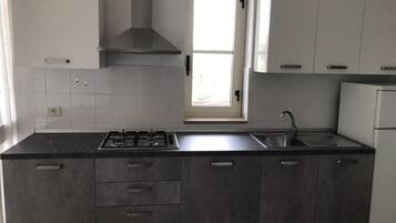 Kylskåp, spishäll, kaffe- och tebryggare och grytor/köksredskap