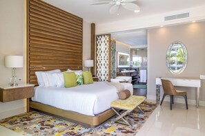 A modern hotel room with a large bed, a desk, and a chair.