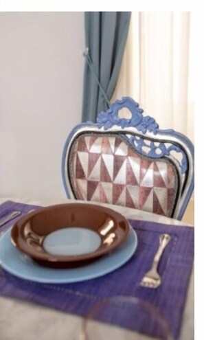 A table for two is set with a plate and silverware.