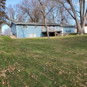 A two-story blue house with a front porch and a small deck. - Family Fun - 2 blocks from everything! (Arnolds Park)