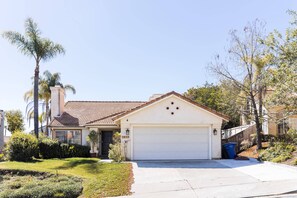 Home sweet home, this cozy abode features a charming front porch, a well-manicured lawn, and a mailbox.