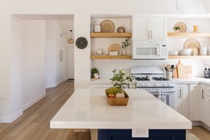 Enjoy cooking in this well-equipped kitchen with appliances, ample storage, and a convenient central island.